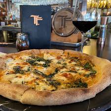 TruFire Kitchen and Bar signature dishes Latin Fire PizzaSpicy Garlic NoodlesSmoked Tomato and Chicken Pasta